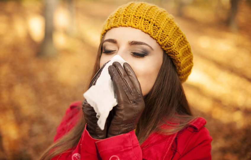 23260660 - woman sneezing in handkerchief at autumn